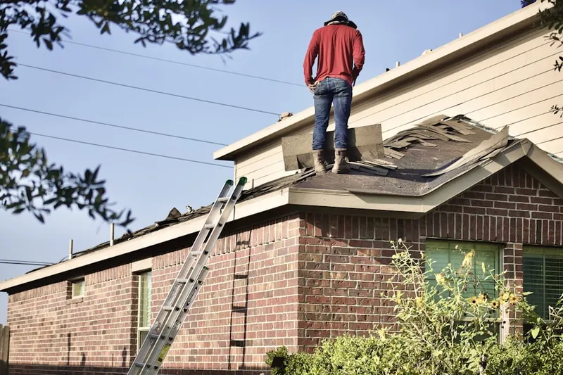 Professional roofer working on a residential roof in Liberty Mills